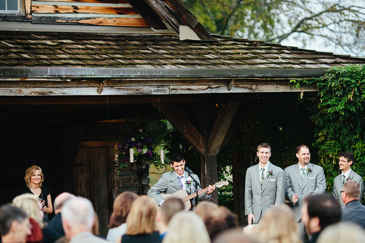 groom playing guitar during ceremony